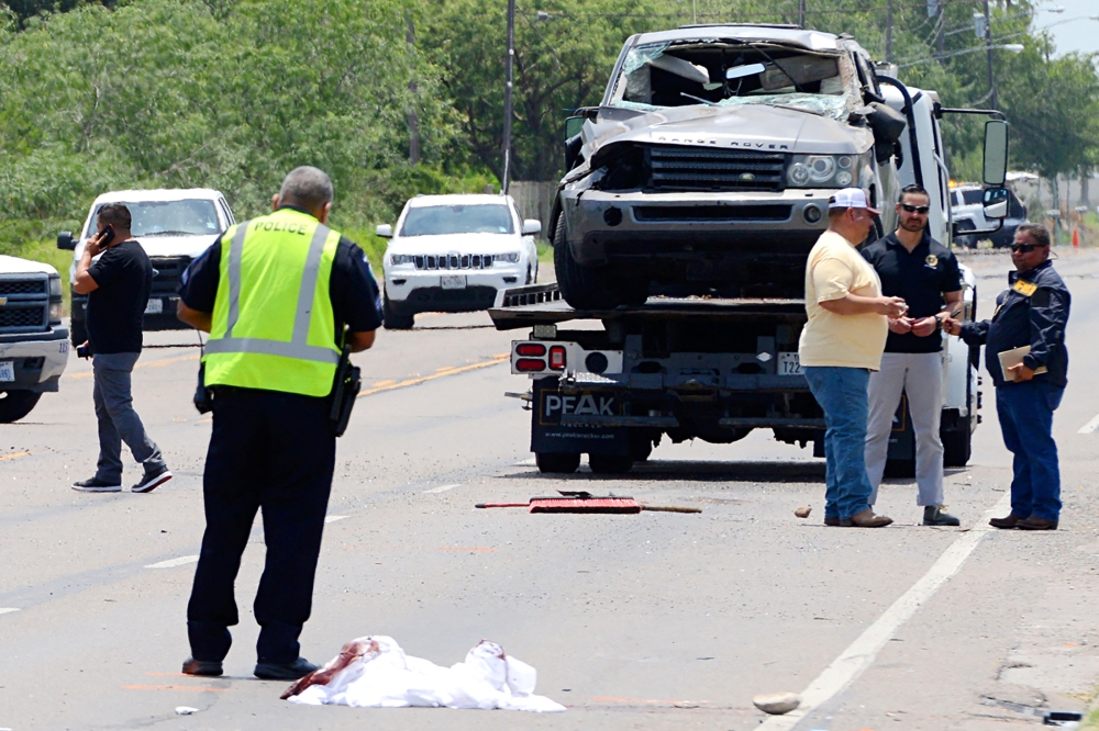 A Range Rover is removed after it ran into pedestrians, killing several at a bus stop near the Ozanam Center, a shelter for migrants and homeless, in Brownsville, Texas  May 7, 2023. — Reuters pic