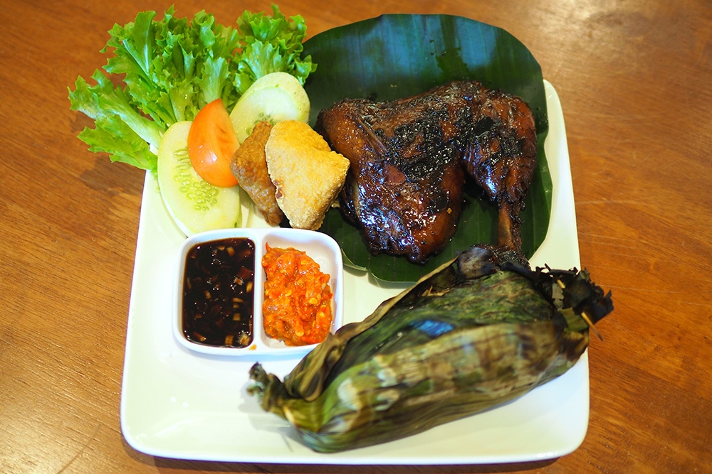 Your meal like this Grilled Chicken is served with ‘nasi bakar’, fried ‘tempeh’ and beancurd and ‘sambal’.
