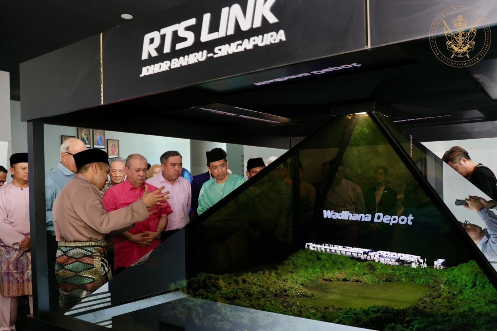 Sultan Ibrahim Sultan Iskandar (in pink) is briefed on the RTS Link during a MRT Corp event in Johor Baru May 11, 2023. — Picture courtesy of the Johor Royal Press Office