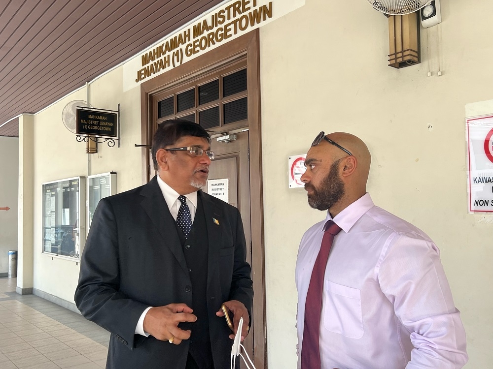 Annapuranee’s son, Greg Jenkins (right), speaking with his counsel, S. Raveentharan, outside the courtroom at the Penang Court Complex on May 12, 2023. ― Picture by Opalyn Mok