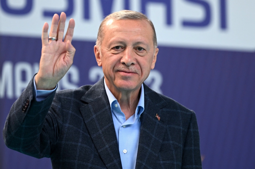 Turkish President Recep Tayyip Erdogan waves to supporters prior to address a speech at a rally in the Beyoglu district on the eve of the presidential and parliamentary elections, on the European side of Istanbul, on May 13, 2023. — AFP pic
