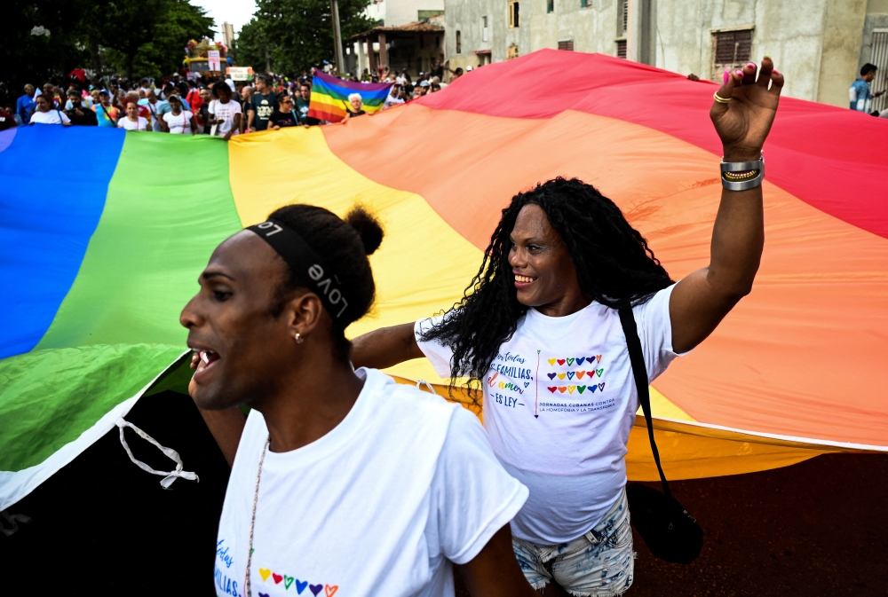 People take part in the gay pride conga to celebrate the day against homophobia and transphobia, in Havana, on May 13, 2023. — AFP pic