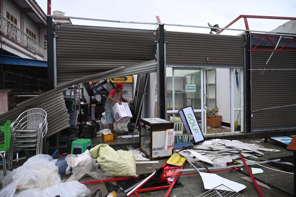 A local resident cleans his shop that was damaged after Cyclone Mocha’s crashed ashore in Kyauktaw. — AFP pic