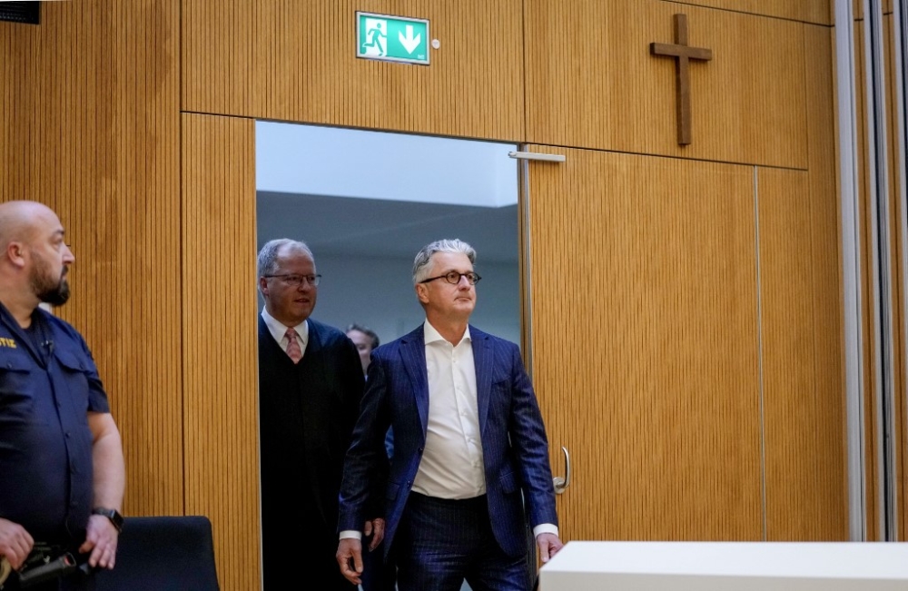Rupert Stadler (right), former CEO of German car manufacturer Audi, arrives in a room of the regional court in Munich, southern Germany, on May 16, 2023. Stadler pleaded guilty in connection with the 'Dieselgate' emissions cheating scandal. — AFP pic