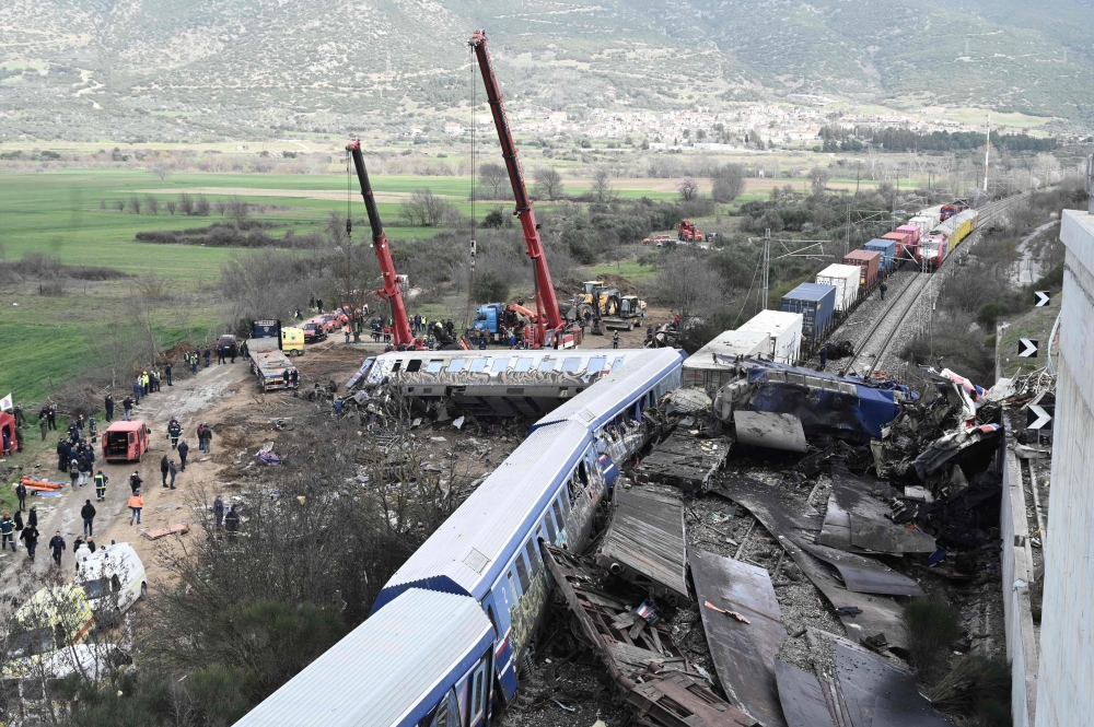 Two carriages were crushed and a third engulfed in fire when a passenger train and a freight train collided in Greece in February. — AFP pic