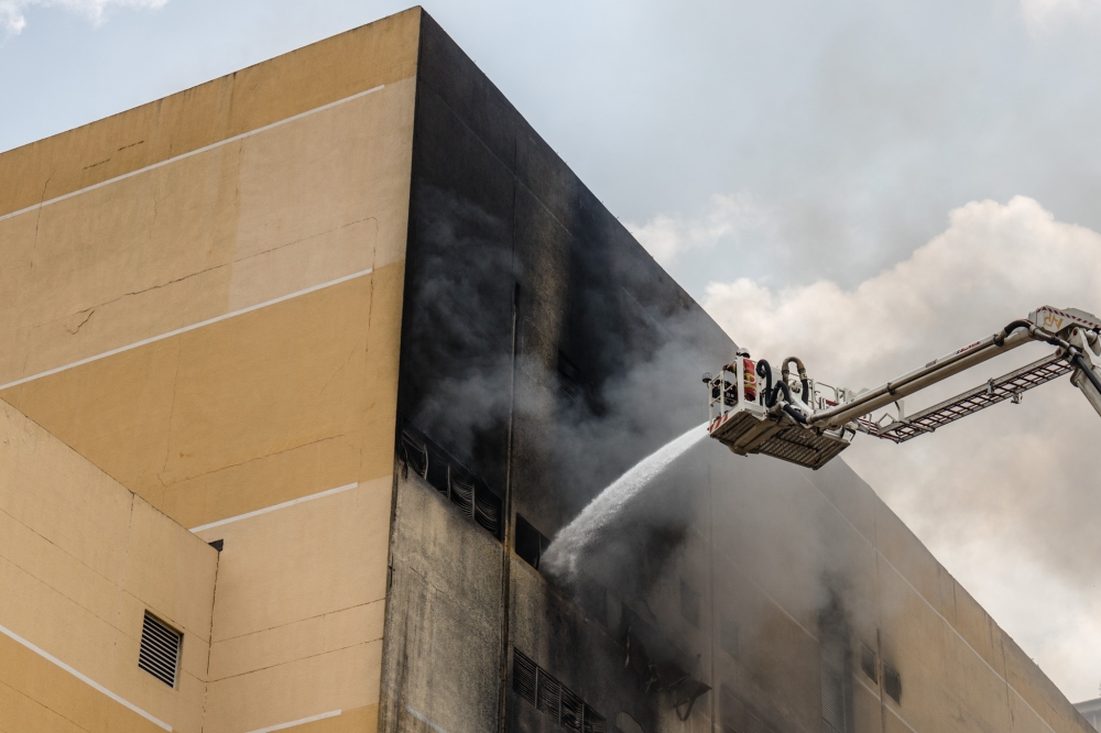 Fire and Rescue Department personnel putting out the fire at Mid Valley Megamall in Kuala Lumpur May 17, 2023. — Picture by Firdaus Latif Picture by Firdaus Latif