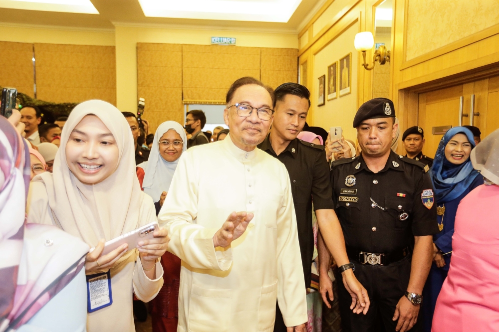 Prime Minister Datuk Seri Anwar Ibrahim greets the crowd as he attends Aidilfitri open house organised by the Prime Minister's Department at Puspanitapuri, Putrajaya May 17, 2023. — Picture by Sayuti Zainudin