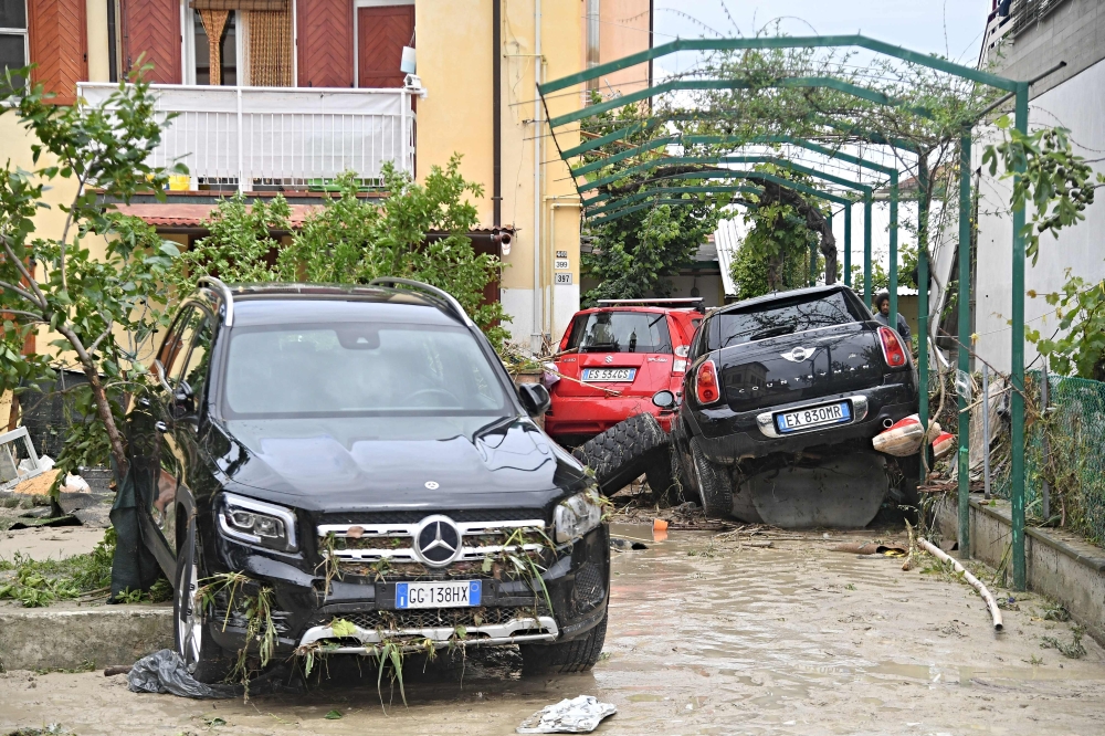 Cars were submerged and in areas where the water had receded, the streets were filled with thick mud and debris. — AFP pic