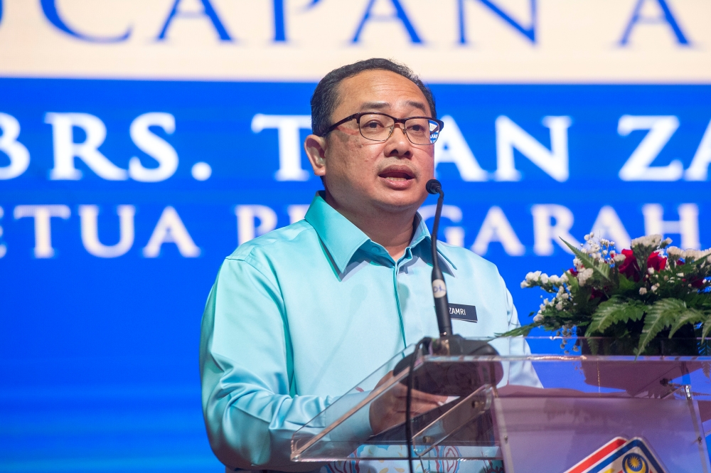 National Registration Department director general Zamri Misman delivers his speech during the department's Excellent Service Award presentation ceremony at Puspanitapuri in Putrajaya 18 May, 2023. — Picture by Shafwan Zaidon