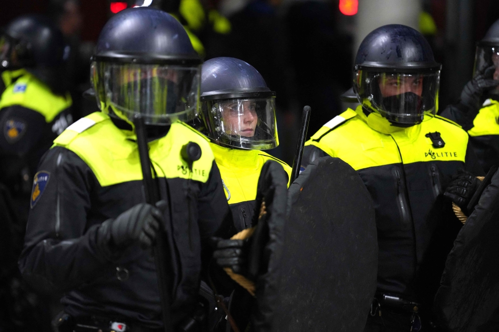Dutch police arrive as riots break out in the stands after the UEFA Conference League semi-final match between AZ Alkmaar and West Ham United FC at the AFAS stadium in Alkmaar May 18, 2023. — ANP/AFP pic