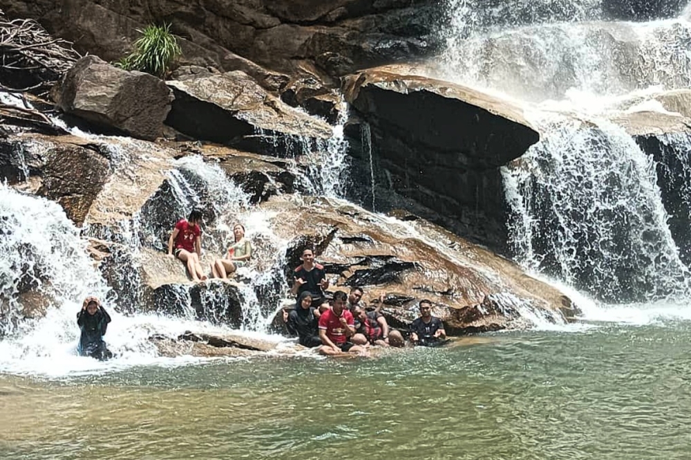 Universiti Malaysia Pahang students seen cooling off at the Sg Pandan waterfall near Kuantan, Pahang. May 18, 2023. — Picture by Muhammad Yusry