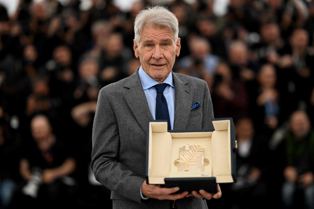 US actor Harrison Ford poses with his Honorary Palme d’Or during a photocall for the film ‘Indiana Jones and the Dial of Destiny’ at the 76th edition of the Cannes Film Festival in Cannes, southern France, on May 19, 2023. ― AFP pic