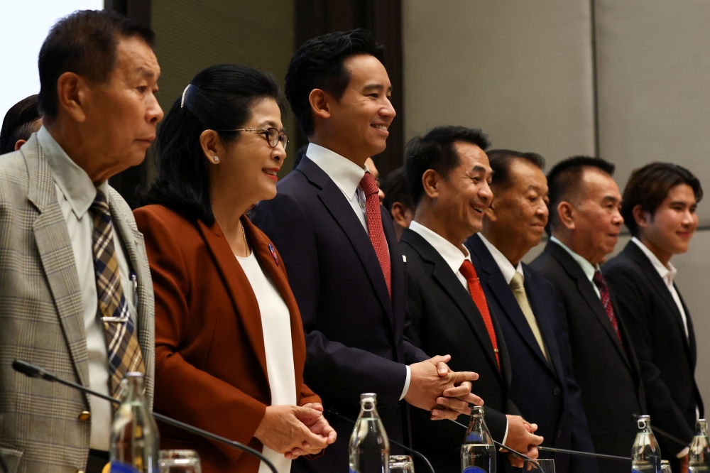 Move Forward Party leader, Pita Limjaroenrat poses with coalition party leaders for a photo following a meeting. — Reuters pic