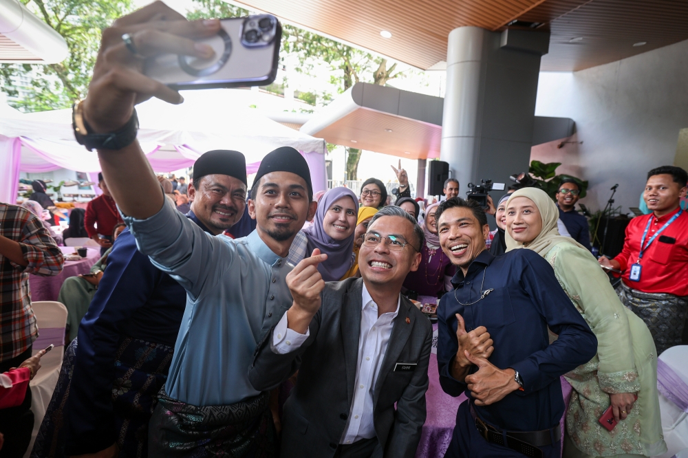 Communications and Digital Minister Fahmi Fadzil poses for a picture with guests at the Malaysian National News Agency’s (Bernama) 56th Anniversary and Aidilfitri Open House celebration at Wisma Bernama, Kuala Lumpur May 22, 2023. — Bernama pic