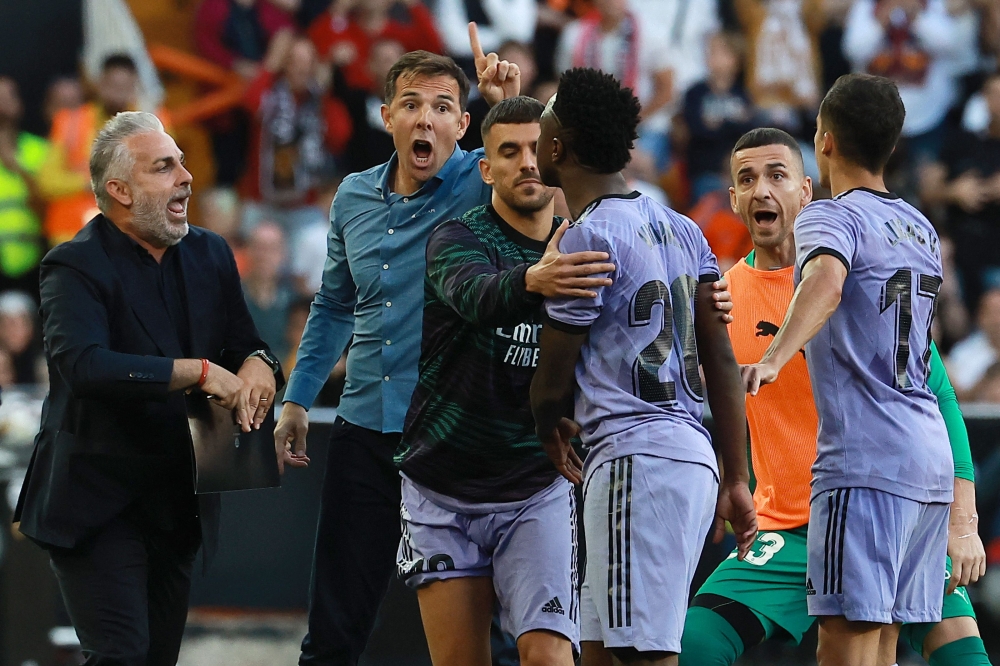Real Madrid's Brazilian forward Vinicius Junior (3rd right) confronts Valencia's officials as he leaves after being sent off the pitch by the referee during the Spanish league football match between Valencia CF and Real Madrid CF at the Mestalla stadium in Valencia May 21, 2023. — AFP pic