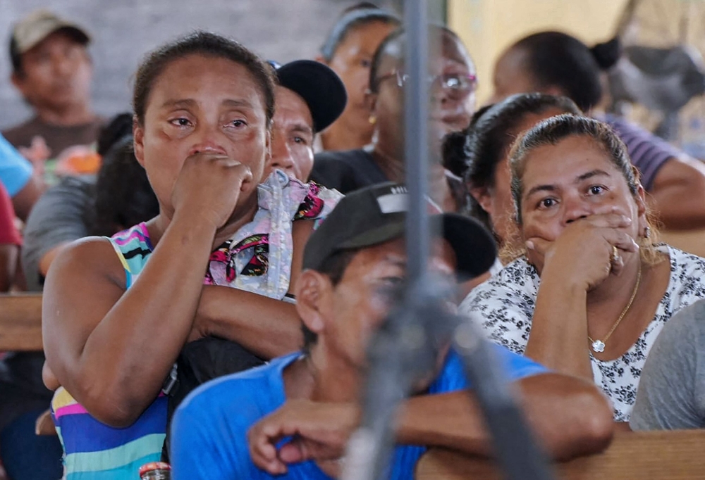 Relatives and friends of the victims of a fire on the eve that killed at least 19 youths and injured about 20 others in a schoolgirls' dormitory, cry during a meeting with Guyana's President Irfaan Ali, in Mahdia, Guyana May 22, 2023. — AFP pic