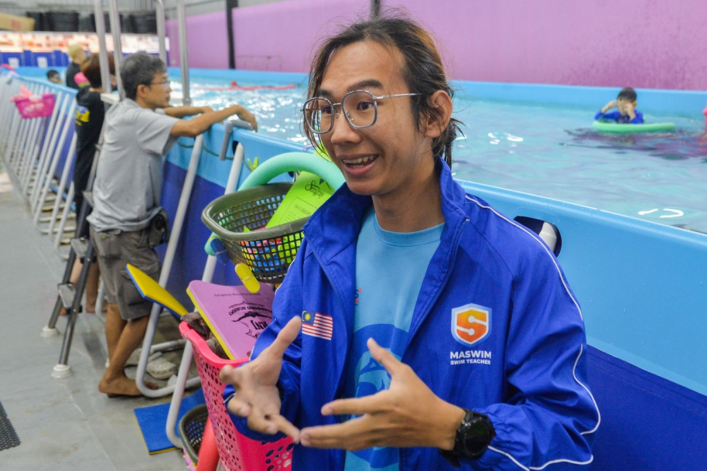 Lead swim instructor Hanson Yan speaks to reporters regarding the free swimming classes provided by the Youth and Sports Ministry for kids from poor households in Petaling Jaya May 21, 2023. — Picture by Miera Zulyana