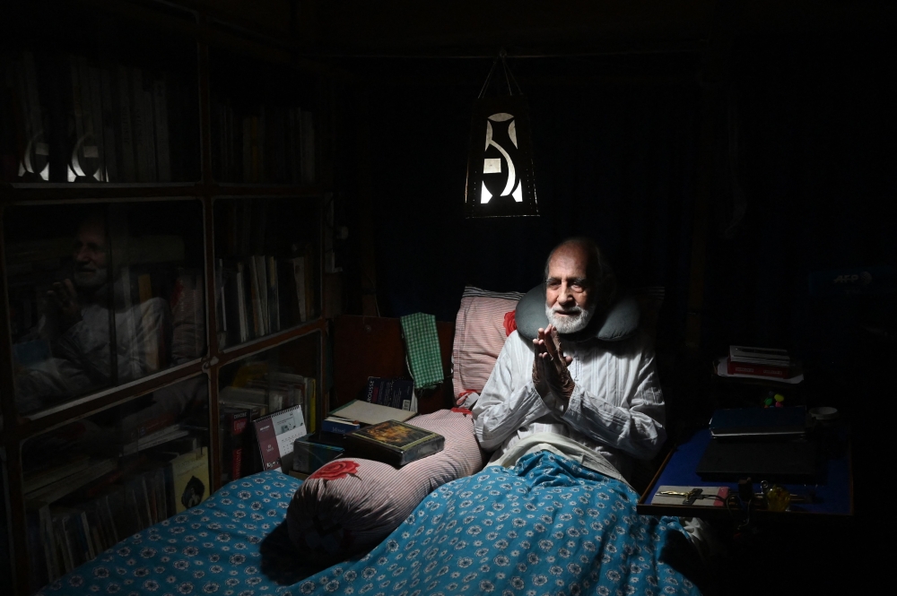 This picture taken on March 19, 2023, shows Brother Gaston Dayanand meditating inside his bedroom. — AFP pic