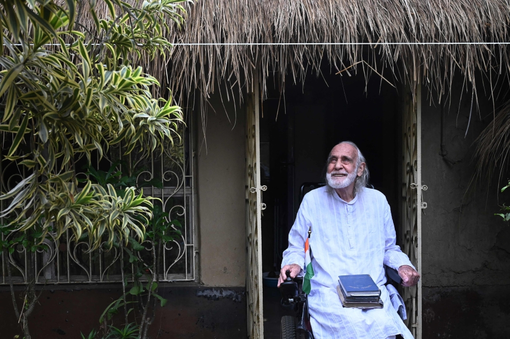 This picture taken on March 19, 2023, shows Brother Gaston Dayanand going for a stroll on his electric wheelchair at the Inter-Religious Center of Development (ICOD) in Gohalapota village, Howrah district, southwest of Kolkata. — AFP pic