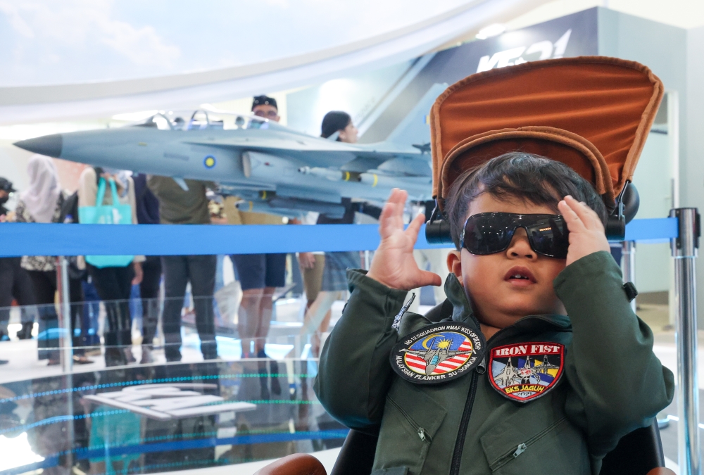 Muhammad Adam Harraz Mohamad Zulhilman, 2, poses in an outfit with aviator patches and sunglasses as he attends Lima ‘23 with his parents in Langkawi May 26, 2023. — Bernama pic