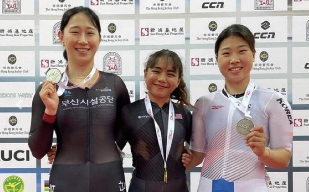 National women’s cyclist Nurul Izzah Izzati Mohd Asri (centre) poses with gold medal after winning gold the women’s sprint category at the 2023 Hong Kong International Track Cup. — Picture courtesy of the National Sports Council