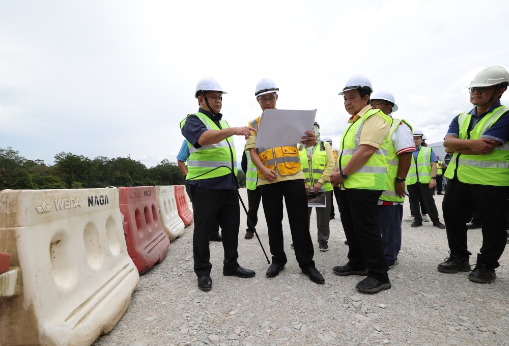 Works Minister Datuk Seri Alexander Nanta Linggi (left) visits the Bukit Begunan section of the Pan Borneo Highway (LPB) project in Sri Aman in this file picture taken on February 6, 2023. — Bernama pic