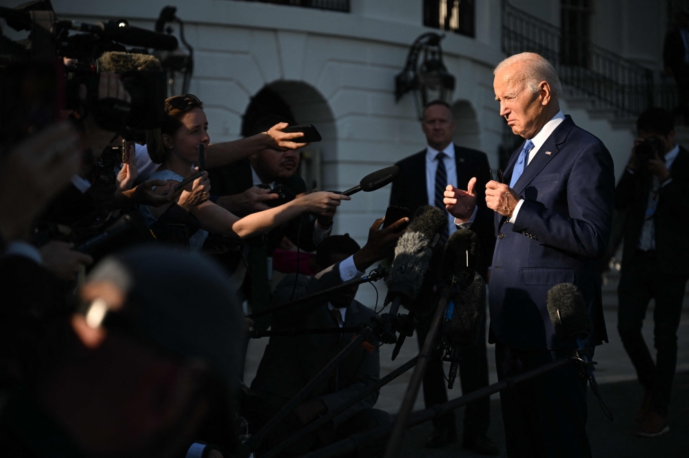 US President Joe Biden speaks with reporters before departing from the South Lawn of the White House on Marine One on May 26, 2023 in Washington, DC. — Reuters pic