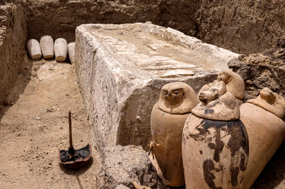 Clay pots and ritual vessels are placed around a stony bed used for mummification, in the Saqqara necropolis south of Cairo, where archaeologists unearthed two human and animal embalming workshops, as well as two tombs, on May 27, 2023. — AFP pic