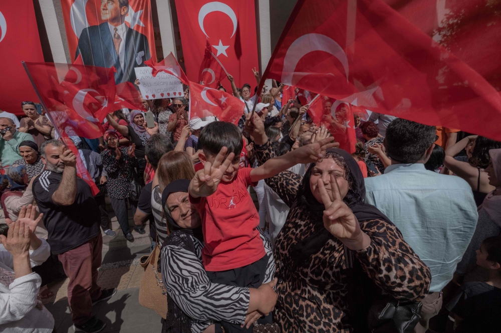 Supporters of Turkey’s Republican People’s Party Chairman and Presidential candidate Kemal Kilicdaroglu wave during a campaign meeting at the municipality theatre in Adana, on May 25, 2023, ahead of the May 28 presidential runoff vote. — AFP pic