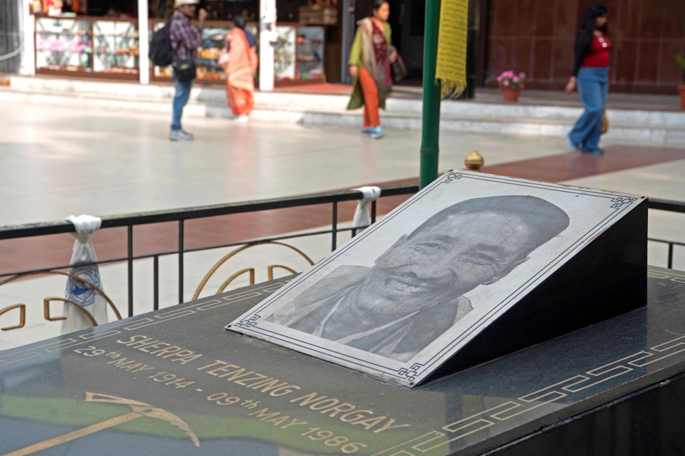 In this photograph taken on May 20, 2023, tourists walk past the crematory of late mountaineer Sherpa Tenzing Norgay at the Himalayan Mountaineering Institute museum, in Darjeeling. — AFP pic