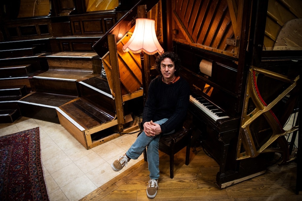 Artist and Musician Tim Vincent-Smith, Co director of Pianodrome, a charity centre aiming a the refurbishing and repairing pianos, poses for photographs in their atelier in a former department store near the port of Leith, in Edinburgh, Scotland, on February 9, 2023. — AFP pic
