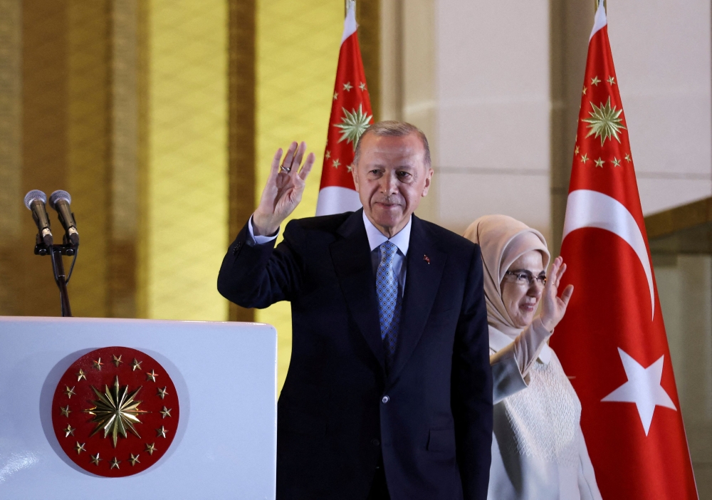 Turkish President Tayyip Erdogan and his wife Ermine Erdogan wave as he addresses his supporters following his victory in the second round of the presidential election at the Presidential Palace in Ankara, Turkey May 28, 2023. — Reuters pic