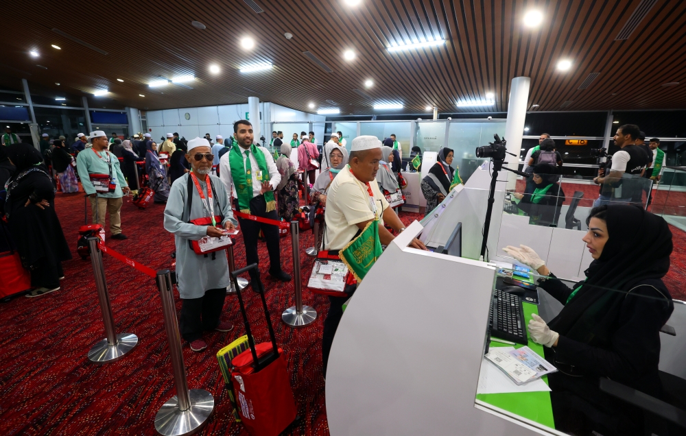 Malaysian Haj pilgrims are seen at Saudi Arabia’s Immigration counters before their flight to Saudi Arabia at the Kuala Lumpur International Airport in Sepang May 21, 2023. — Bernama pic