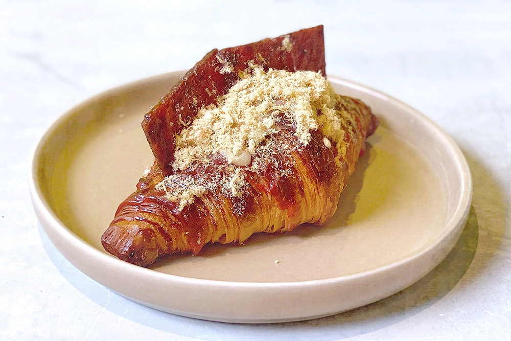 A croissant topped with fluffy meat floss and sticky ‘bakkwa’.