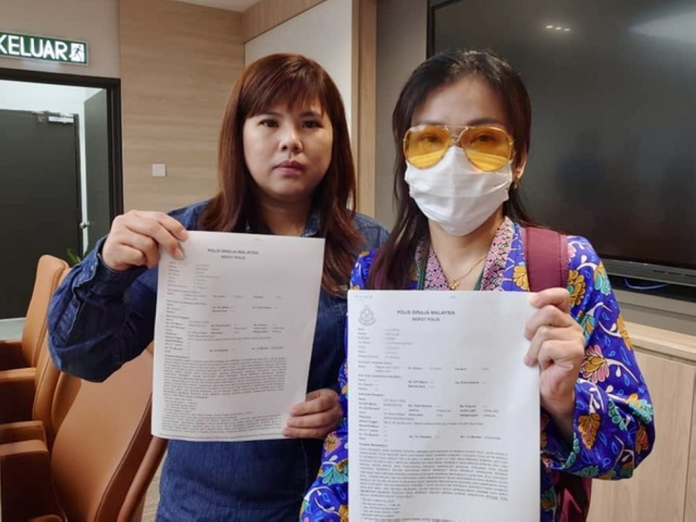 Lee Guan Yoke (right) shows copies of her police reports at the Johor MCA state liaison committee office in Johor Baru May 30, 2023. — Picture by Ben Tan