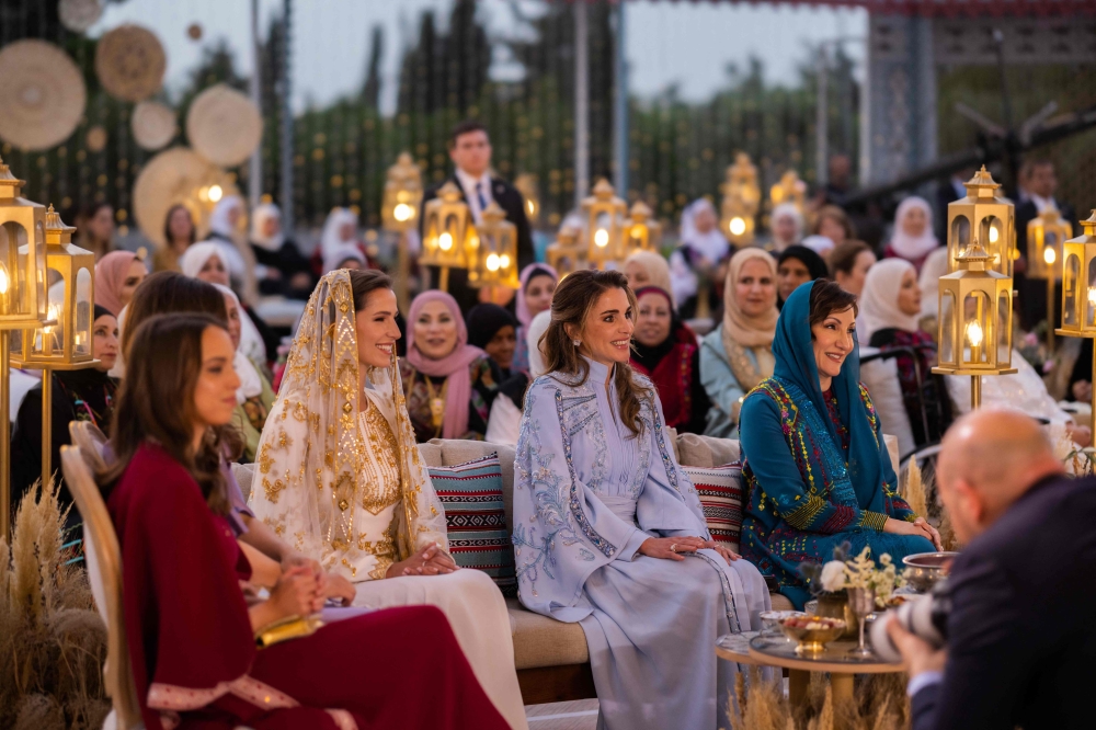 A handout picture released by the Press Service of Jordanian Queen Rania, shows her (centre) holding a dinner party in Amman on May 22, 2023 in celebration of Crown Prince Hussein and Saudi fiancee Rajwa al-Saif's upcoming wedding. — Photo by Office of Her Majesty Queen Rania Al Abdullah / AFP