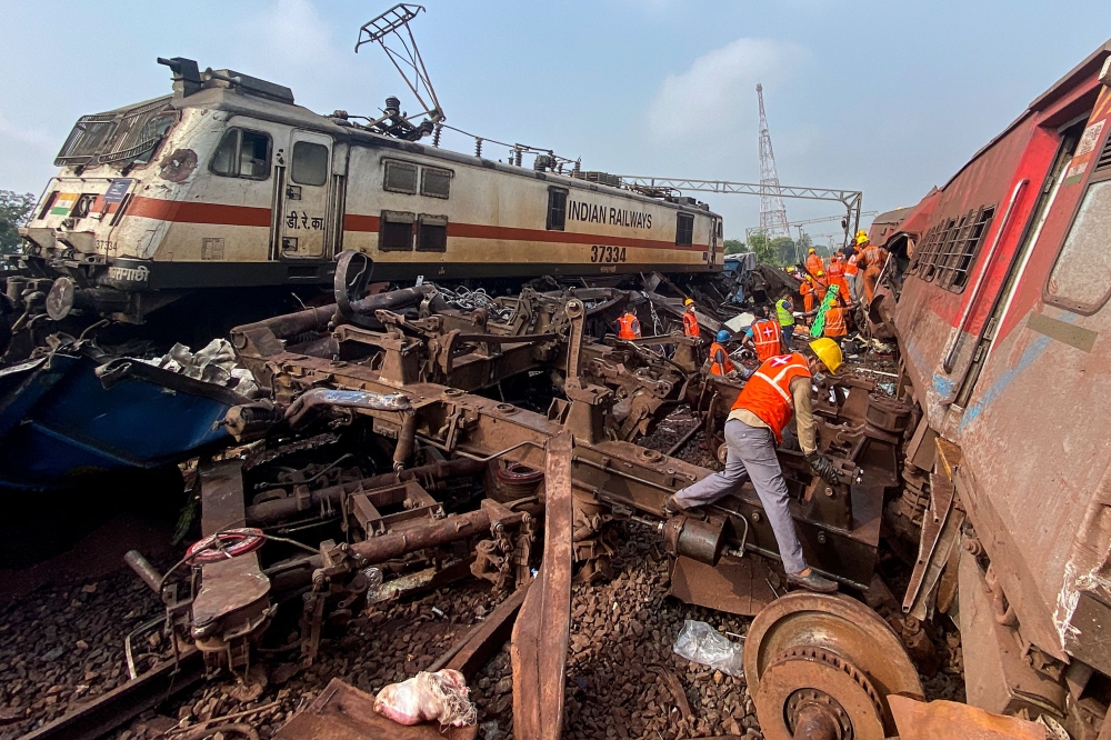 Rescue workers at the accident site of a three-train collision near Balasore. — AFP pic
