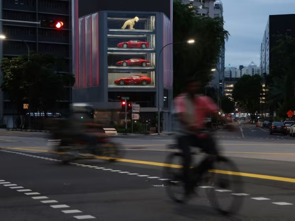 Luxury cars on display in a 15-storey showroom designed to resemble a vending machine. — TODAY pic