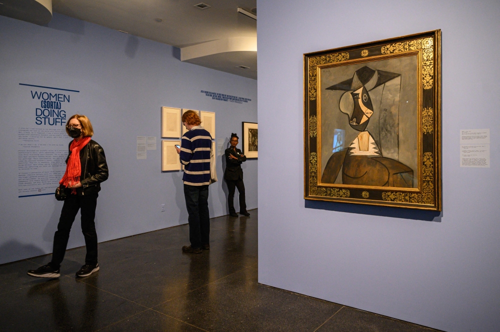 People walk past a work of art by Pablo Picasso titled ‘Woman in Grey’ on display at an exhibition titled ‘It’s Pablo-matic: Picasso According to Hannah Gadsby’ at the Brooklyn Museum. — AFP pic