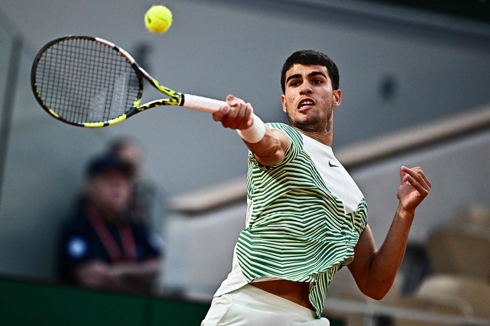 Spain's Carlos Alcaraz Garfia plays a forehand return to Canada's Denis Shapovalov during their men's singles match on day six of the Roland-Garros Open tennis tournament at the Court Philippe-Chatrier in Paris on June 2, 2023. — AFP pic