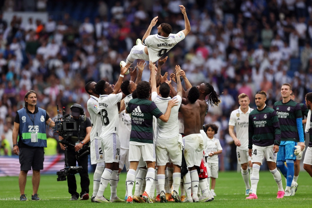 Real Madrid's French forward Karim Benzema is tossed in the air by teammates at the end of the Spanish league football match between Real Madrid CF and Athletic Club Bilbao at the Santiago Bernabeu stadium in Madrid June 4, 2023. — AFP pic
