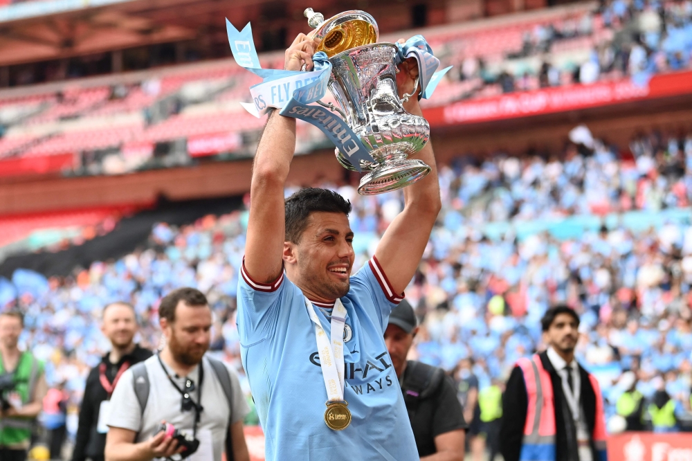 Manchester City's Spanish midfielder Rodri celebrates with the trophy on the pitch after the English FA Cup final football match between Manchester City and Manchester United at Wembley stadium, in London June 3, 2023. — AFP pic