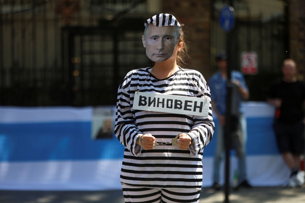 A demonstrator from the Russian Democratic Society, dressed in a costume with a mask depicting Russian President Vladimir Putin, takes part in a rally to demand the release of all political prisoners in Russia, outside the Russian Embassy in London June 4, 2023. Several Russian radio stations were hacked and played a fake President Vladimir Putin speech announcing an invasion from Kyiv’s troops and emergency measures in three regions bordering Ukraine. — Reuters pic