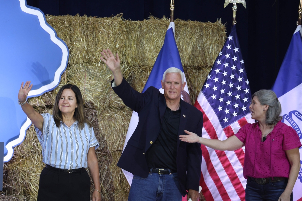 Republican presidential candidate former Vice President Mike Pence and his wife Karen are introduced by Senator Joni Ernst during the Joni Ernst's Roast and Ride event on June 3, 2023 in Des Moines, Iowa. — AFP pic