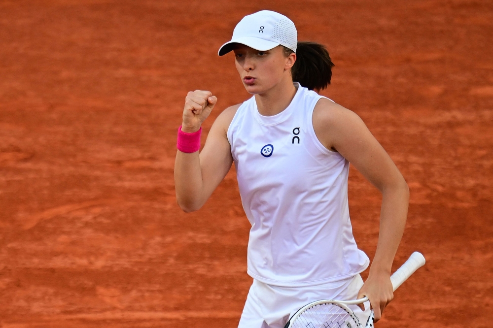 Poland's Iga Swiatek reacts as she plays against Ukraine's Lesia Tsurenko during their women's singles match on Day Nine of the Roland-Garros Open tennis tournament at the Court Suzanne-Lenglen in Paris June 5, 2023. — AFP pic