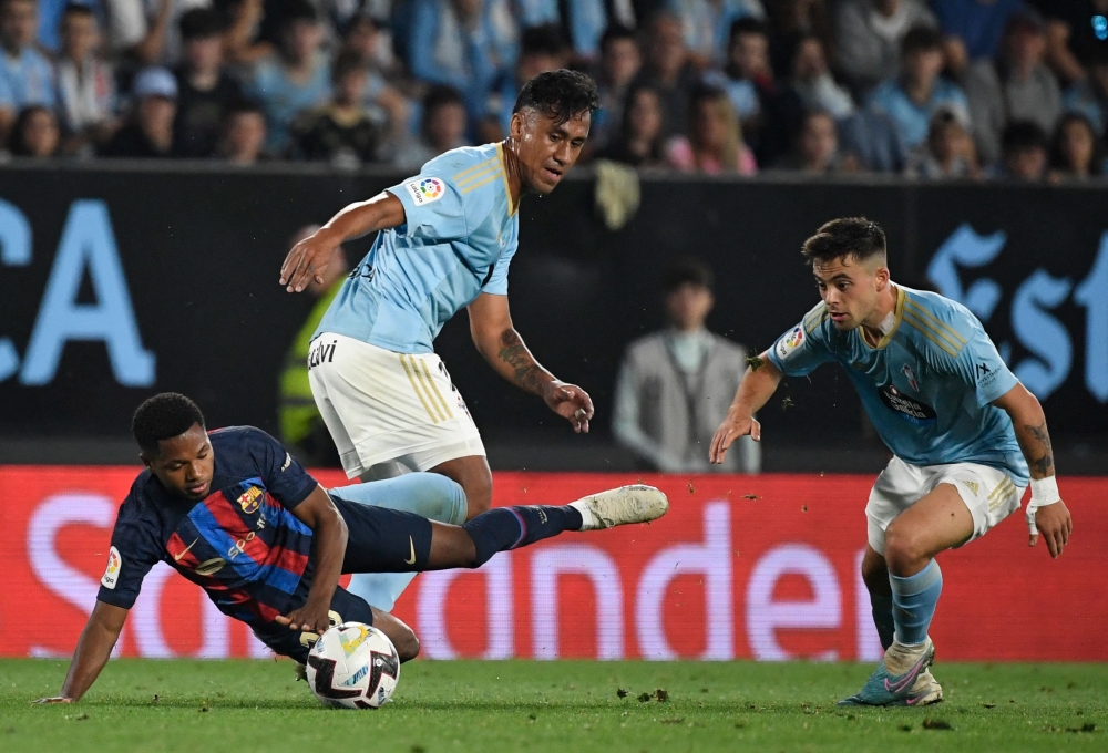 Barcelona's Spanish forward Ansu Fati (left) vies with Celta Vigo's Peruvian midfielder Renato Tapia (centre) and Celta Vigo's Spanish defender Javi Galan during the Spanish league football match between RC Celta de Vigo and FC Barcelona at the Balaidos stadium in Vigo June 4, 2023. — AFP pic