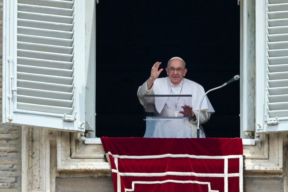 Pope Francis waves from the window of the apostolic palace overlooking St. Peter's square during the weekly Angelus prayer on June 4, 2023 in The Vatican. — AFP pic