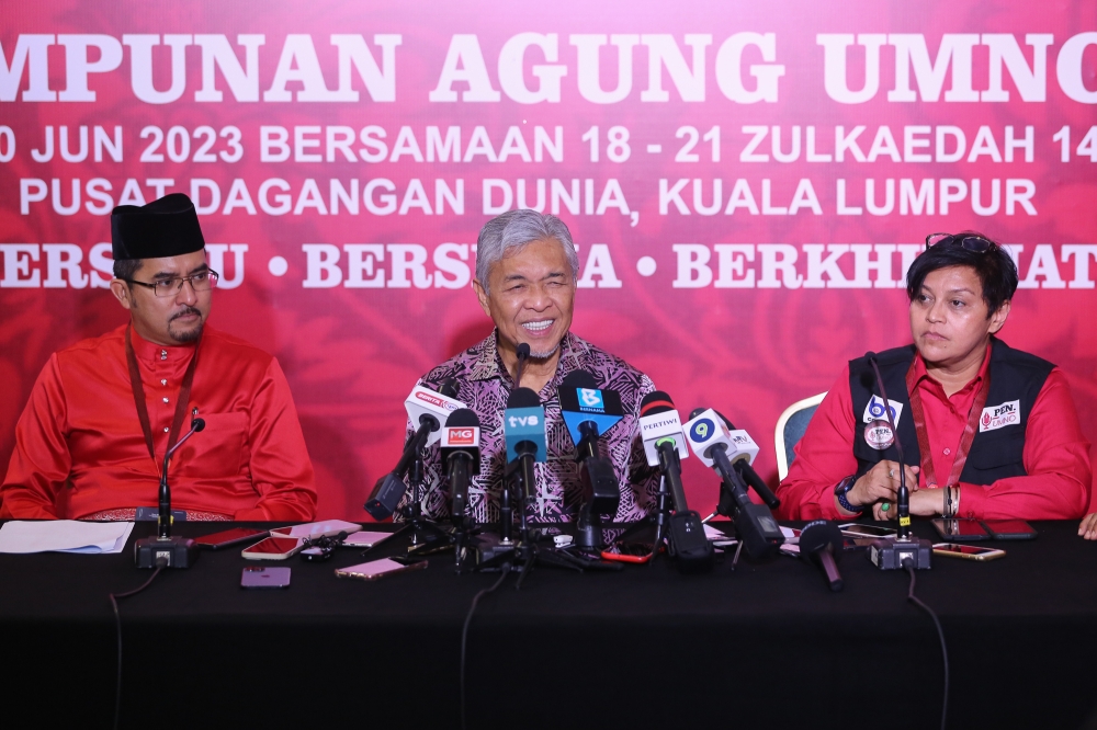 Umno president Datuk Seri Ahmad Zahid Hamidi (centre) speaks during a press conference at the party’s 2023 general assembly at the World Trade Centre in Kuala Lumpur June 8, 2023. Flanking him are Umno secretary-general Datuk Asyraf Wajdi Dusuki and Umno Information chief Datuk Seri Azalina Othman Said. — Picture by Yusof Mat Isa
