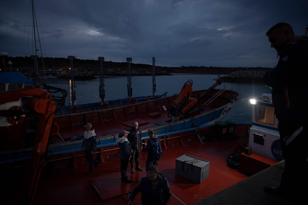 Tuna fishers prepare their boat prior to putting out to the waters of the Strait of Gibraltar to catch bluefin tuna using the ancient fishing technique of almadraba, early on May 18, 2023 in the port of Conil de la Frontera, southern Spain. — AFP pic 