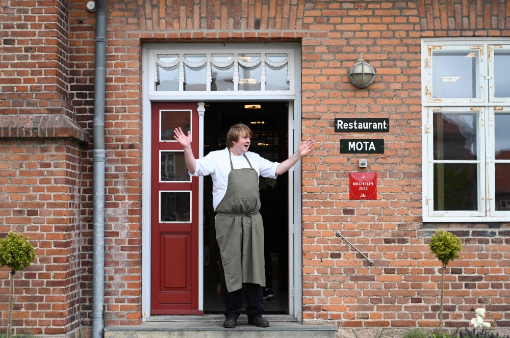 Claus Henriksen, chef of the Mota restaurant, gestures at the entrance of his restaurant in Anneberg Cultural Park, Denmark, on May 24, 2023. — AFP pic 